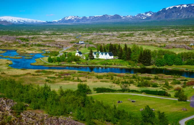 The green landscapes of Thingvellir National Park with Thingvallakirkja Church