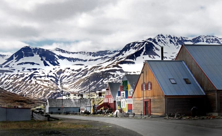 Colourful houses and a snowy mountain in Siglufjordur town.