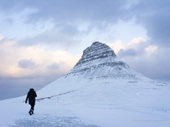 A person next to Mt. Kirkjufell on the Snaefellsnes Peninsula