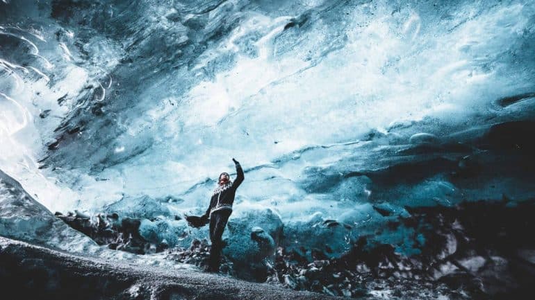 Un homme debout à l'intérieur d'une grotte de glace en Islande
