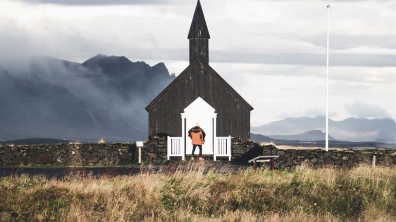 In front of the black Budarkirkja Church on the Snaefellsnes Peninsula.