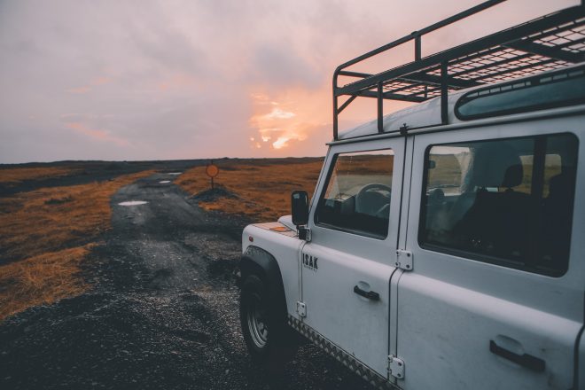 A white van in front of a sunset in Iceland