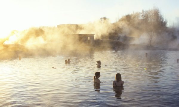 People in warm, geothermal water at the Secret Lagoon in South Iceland.