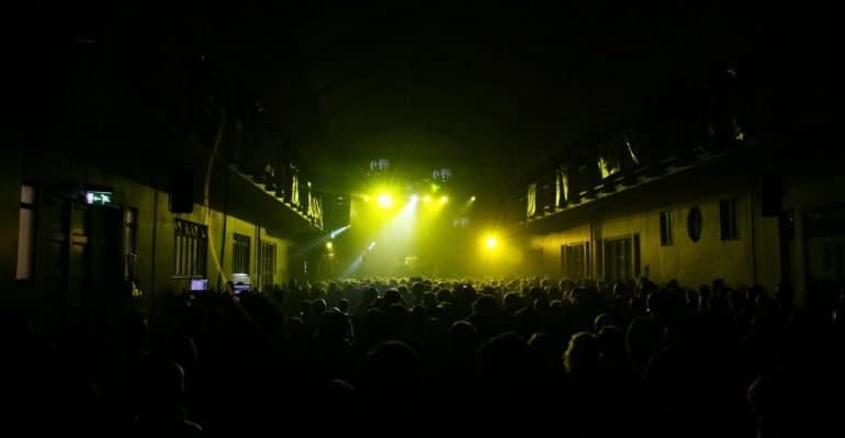 Yellow lights illuminating a concert at Iceland Airwaves.