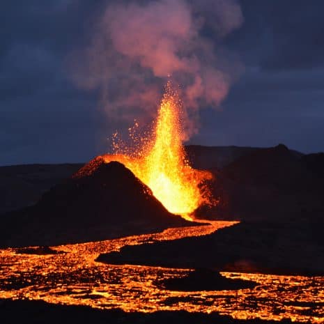 A caldera spewing lava in the night.