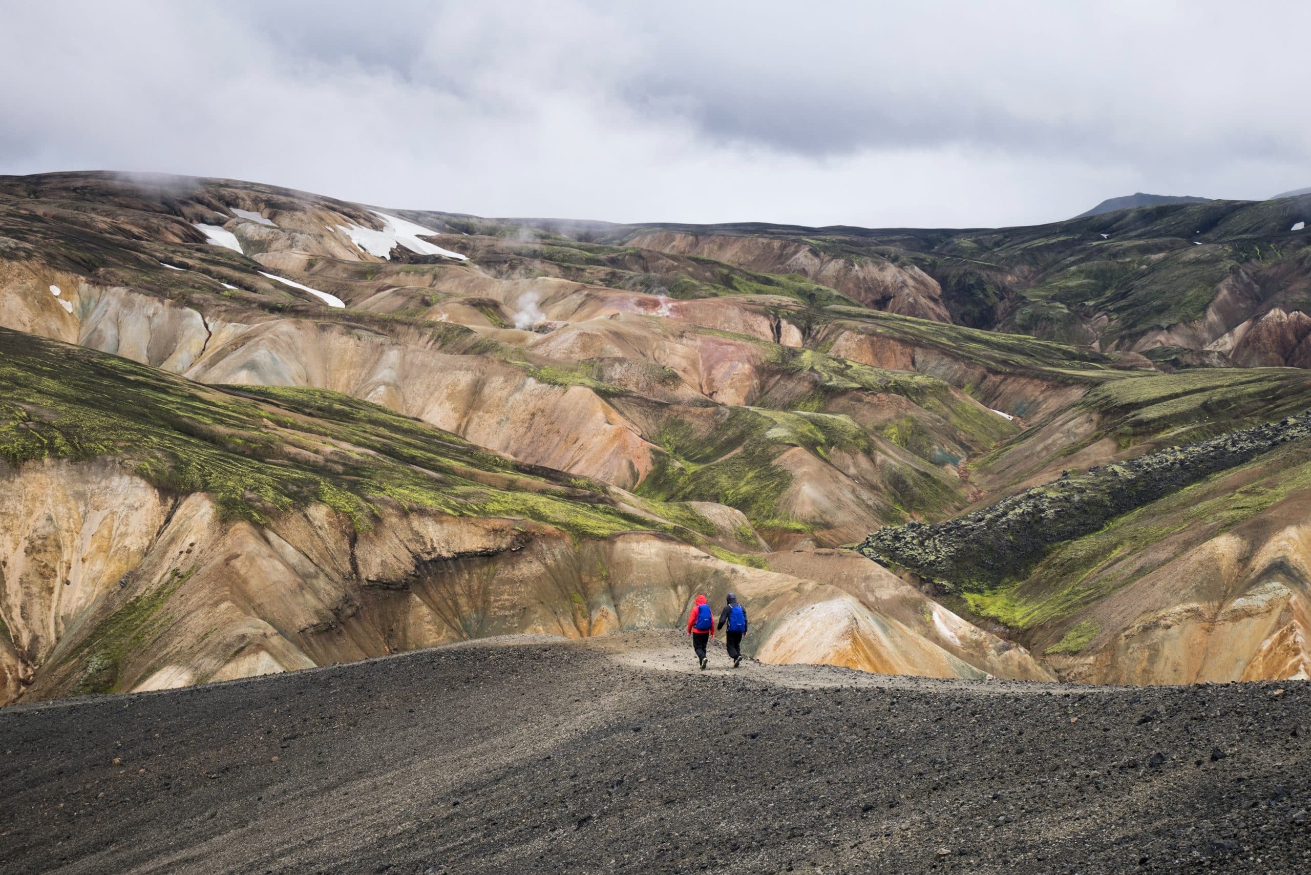 Two people hiking in the Landmannalaugar Region in Iceland's Highlands.
