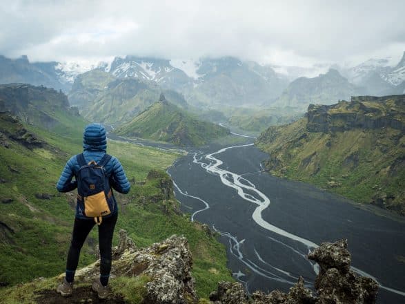 A hiker overlooking a river in the Icelandic Highlands