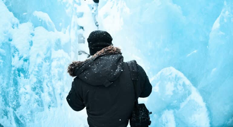 A man stepping inside an ice cave in Iceland.