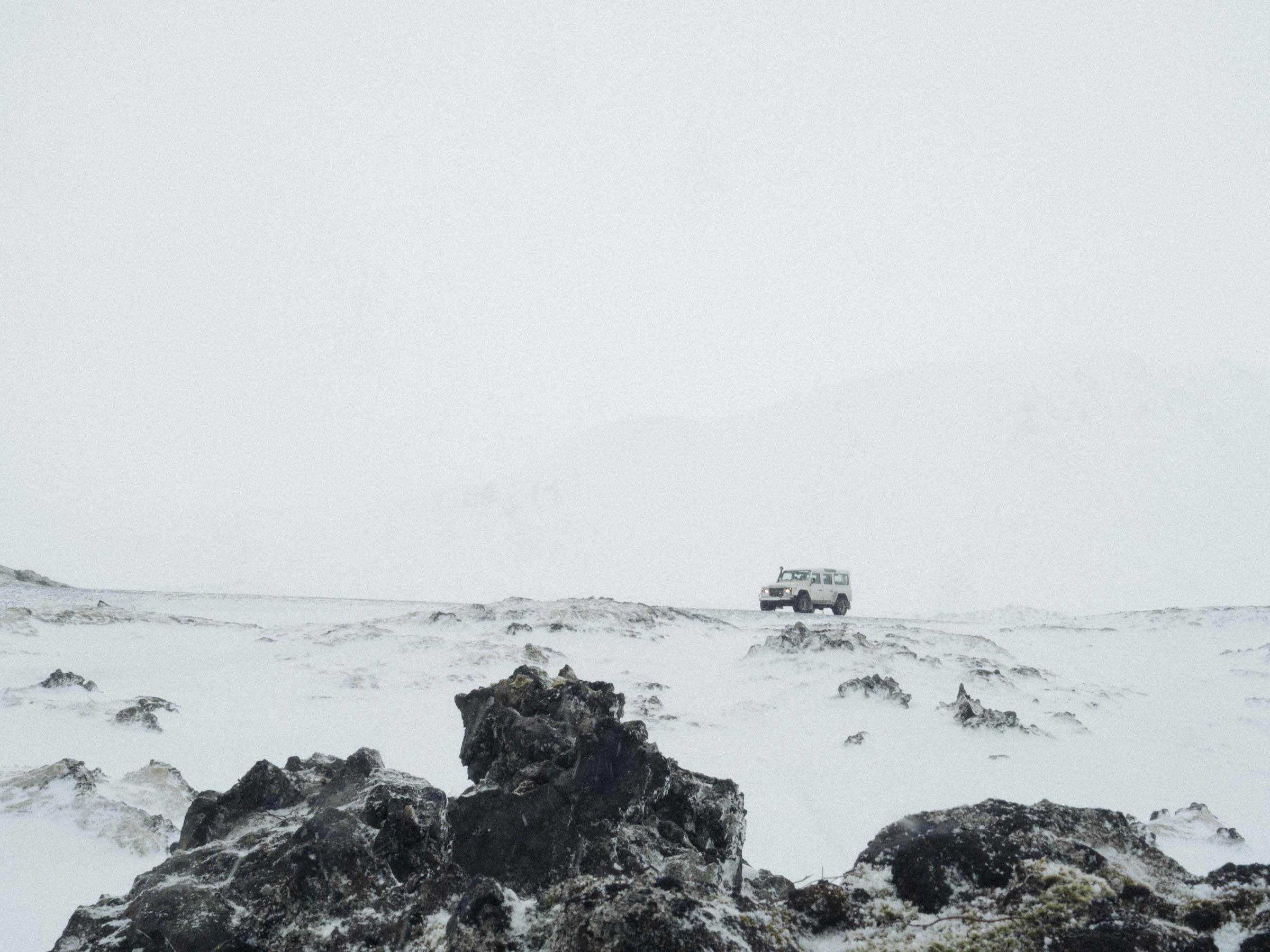 A car driving in a snowstorm in Iceland.