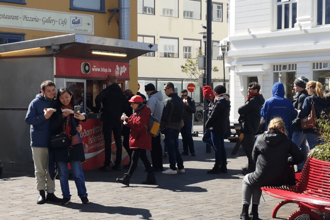 People in a queue in front of Bæjarins Beztu Hot Dog Stand in Reykjavik