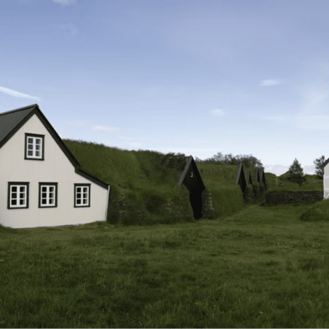 Traditional turf houses and an old church in South Iceland