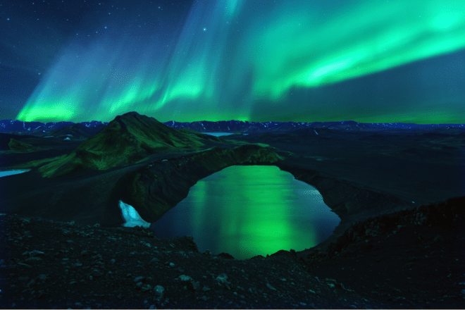 Northern lights over a lake in Landmannalaugar, Iceland.