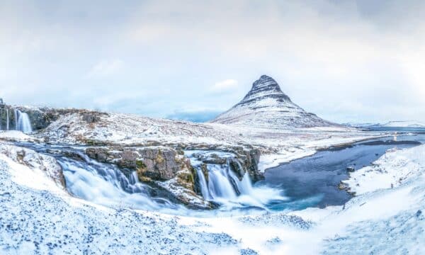 A view of the Kirkjufell mountain and Kirkjufellsfoss waterfall in winter. Iceland.