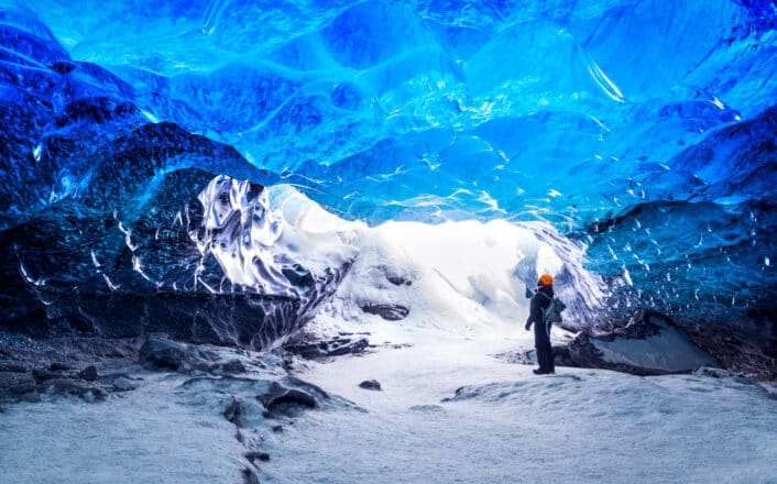 Man standing in an ice cave in Iceland