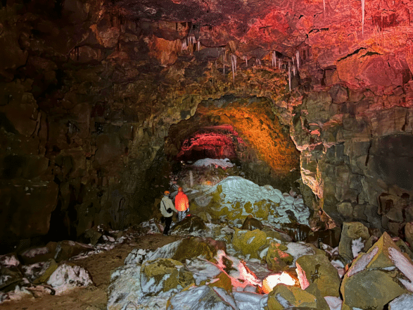 A couple inside Raufarhólshellir Lava Cave in Iceland.