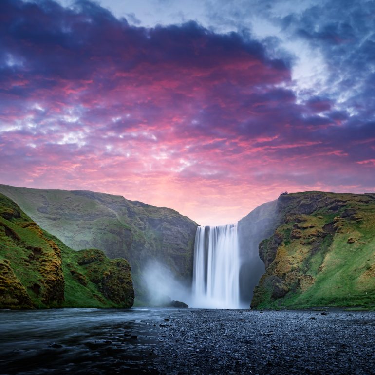 Purple sky over Skógafoss Waterfall in South Iceland.